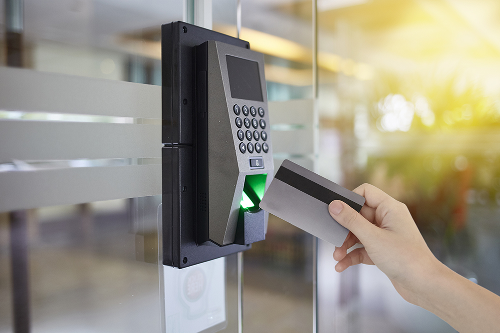 Young woman hold key card to access door office